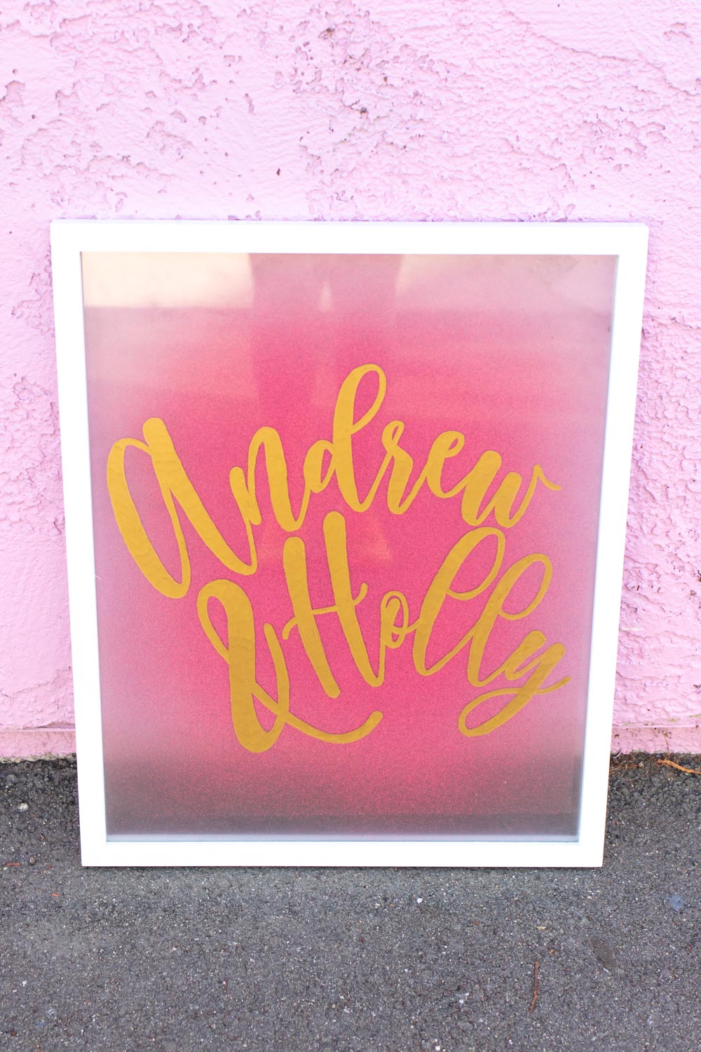 Easy DIY Calligraphy Wedding Sign // Use a large photo frame to make your own custom wedding signage with Rust-Oleum spray paints! Trace your names or sayings, then let it pop off the glass with the new Imagine collection of glitter spray paint available at @joann! #ad #handmadewithjoann #weddingdiy #diywedding #weddingsign #spraypainting #calligraphy #diyideas #homedecor