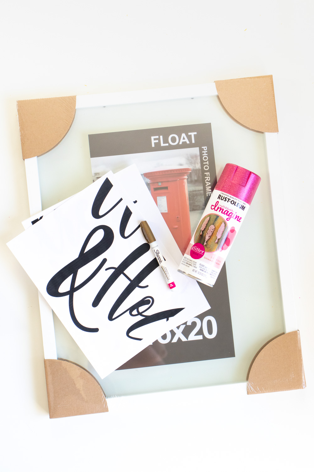 Easy DIY Calligraphy Wedding Sign // Use a large photo frame to make your own custom wedding signage with Rust-Oleum spray paints! Trace your names or sayings, then let it pop off the glass with the new Imagine collection of glitter spray paint available at @joann! #ad #handmadewithjoann #weddingdiy #diywedding #weddingsign #spraypainting #calligraphy #diyideas #homedecor