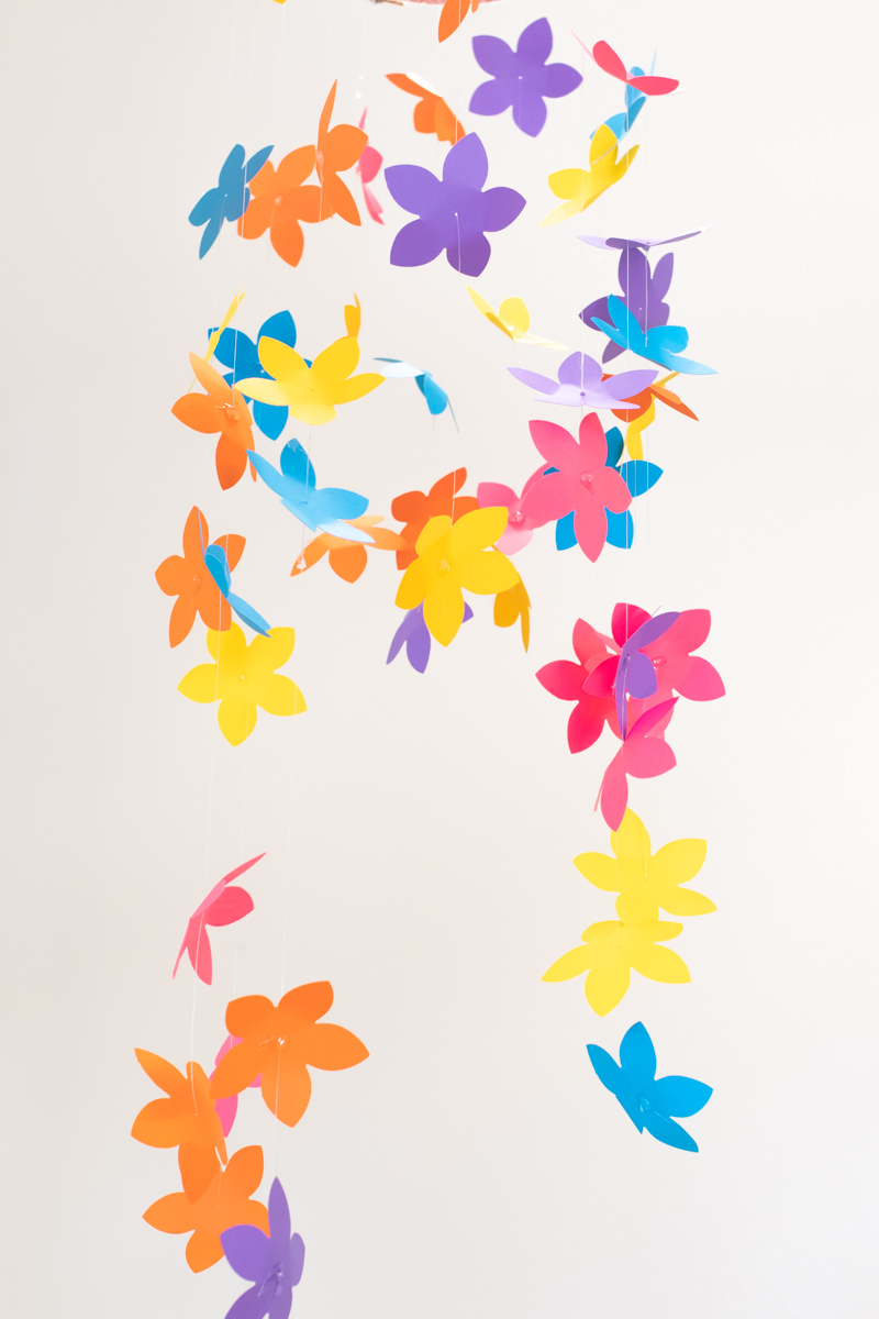 Colorful Spring Party with DIY Paper Decor / Use vibrant Astrobrights cardstock to create a variety of paper party decor for a spring celebration! Whether you're celebrating a Mother's Day brunch, bachelorette weekend or just-because party, thes bright spring party ideas will POP! Make paper wrapped vases as a unique centerpiece accompanied by a paper floral chandelier, floral straws, paper napkin rings and simple homemade confetti #ad #partyideas #springdecor #papercrafts #diyparty #partydecor #paperparty #paperdecor #mothersday #easterbrunch #rainbowparty #floraldecor #birthdayparty #springparty