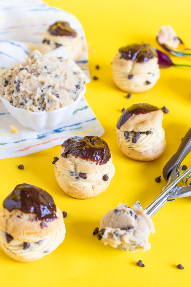 Cookie Dough Cream Puffs // Try this classic cream puff recipe with tips for making perfect pate a choux with a brown sugar pastry cream that tastes like cookie dough! These tasty edible cookie dough-like treats are perfect for parties #creampuffs #frenchpatisserie #frenchfood #dessertrecipes #cookiedough #cookierecipes #frenchbaking #pastries #pastryrecipes #partydesserts