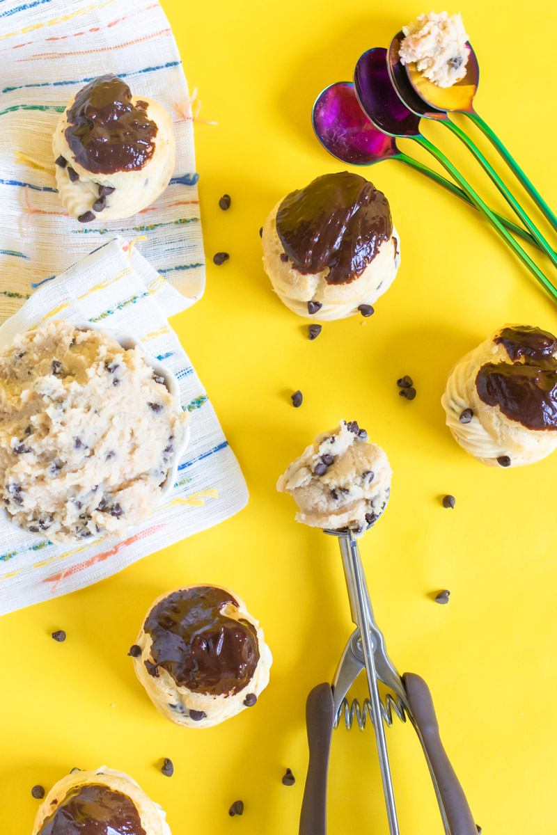 Cookie Dough Cream Puffs // Try this classic cream puff recipe with tips for making perfect pate a choux with a brown sugar pastry cream that tastes like cookie dough! These tasty edible cookie dough-like treats are perfect for parties #creampuffs #frenchpatisserie #frenchfood #dessertrecipes #cookiedough #cookierecipes #frenchbaking #pastries #pastryrecipes #partydesserts
