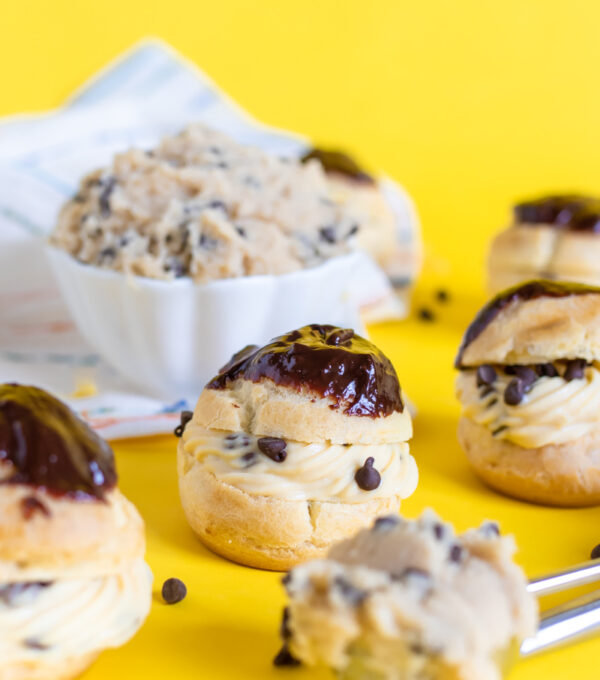 Cookie Dough Cream Puffs // Try this classic cream puff recipe with tips for making perfect pate a choux with a brown sugar pastry cream that tastes like cookie dough! These tasty edible cookie dough-like treats are perfect for parties #creampuffs #frenchpatisserie #frenchfood #dessertrecipes #cookiedough #cookierecipes #frenchbaking #pastries #pastryrecipes #partydesserts
