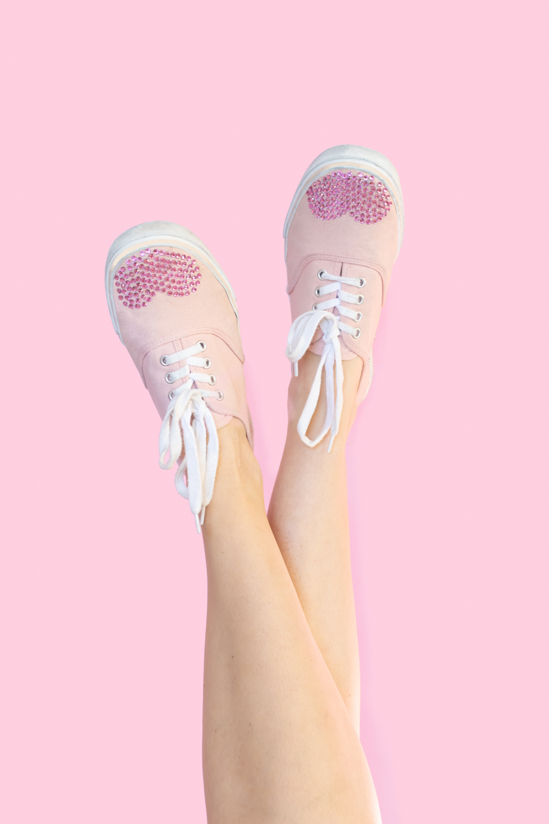 DIY Crystal Valentine's Day Shoes // Makeover old sneakers with colored crystals or rhinestones using Aleene's The Ultimate glue! This easy shoe update is perfect for Valentine's Day or any day of the year! #ad #shoemakeover #upcycle #stylediy #diystyle #shoediy #easydiy #diysforteens #craftsforteens #valentinesday #valentinesdaydiy #vdaydiy