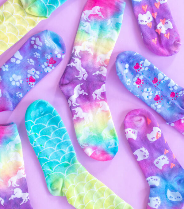 DIY Tie Dye Grip Socks // These easy DIY tie dye socks are the perfect craft for teens and young adults! Use a Tulip kit to make these colorful socks with painted neon grip for no-slip socks everyone needs #ad #tiedye #dyeing #nosew #painting #fabricpaint #kidscrafts #diysforteens #craftsforteens #teencrafts #slumberparty