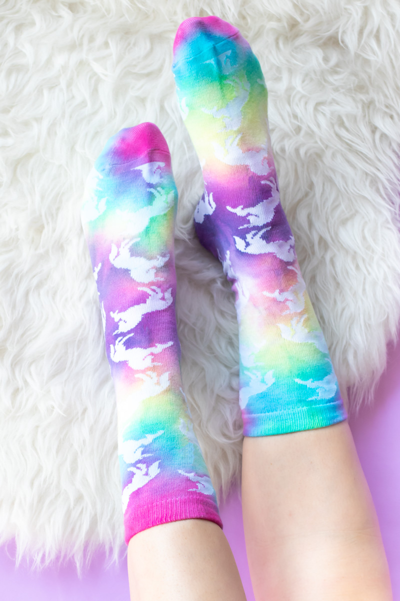 DIY Tie Dye Grip Socks // These easy DIY tie dye socks are the perfect craft for teens and young adults! Use a Tulip kit to make these colorful socks with painted neon grip for no-slip socks everyone needs #ad #tiedye #dyeing #nosew #painting #fabricpaint #kidscrafts #diysforteens #craftsforteens #teencrafts #slumberparty