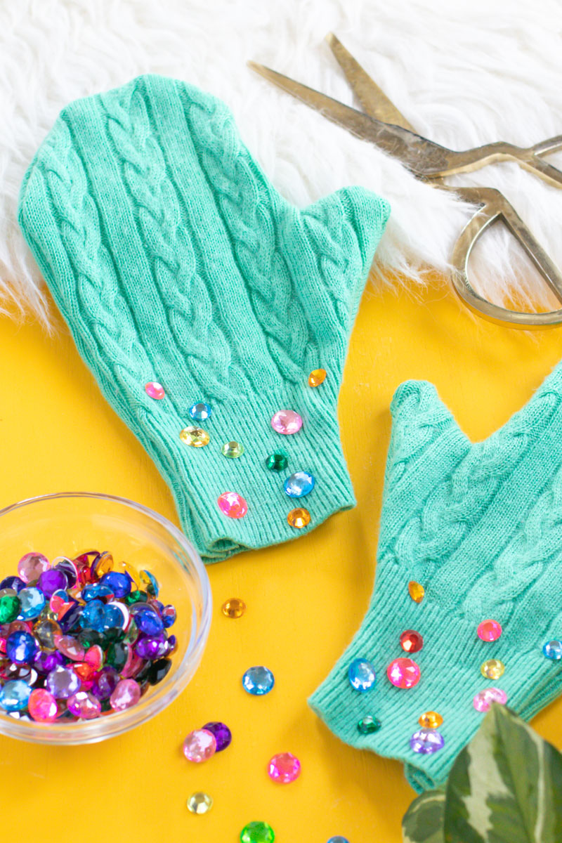Upcycled Sweater DIY! Easy No-Sew Mittens // This easy upcycling DIY is perfect for giving new life to a thrifted sweater or old piece of clothing! Use a sweater and Aleene's Fabric Fusion to make no-sew mittens perfect for keeping warm this season. Add rhinestones for a little extra bling! #ad #nosew #diyfashion #diystyle #upcycledcrafts #bedazzled #nosewfashion #winterdiy #thrifteddiy