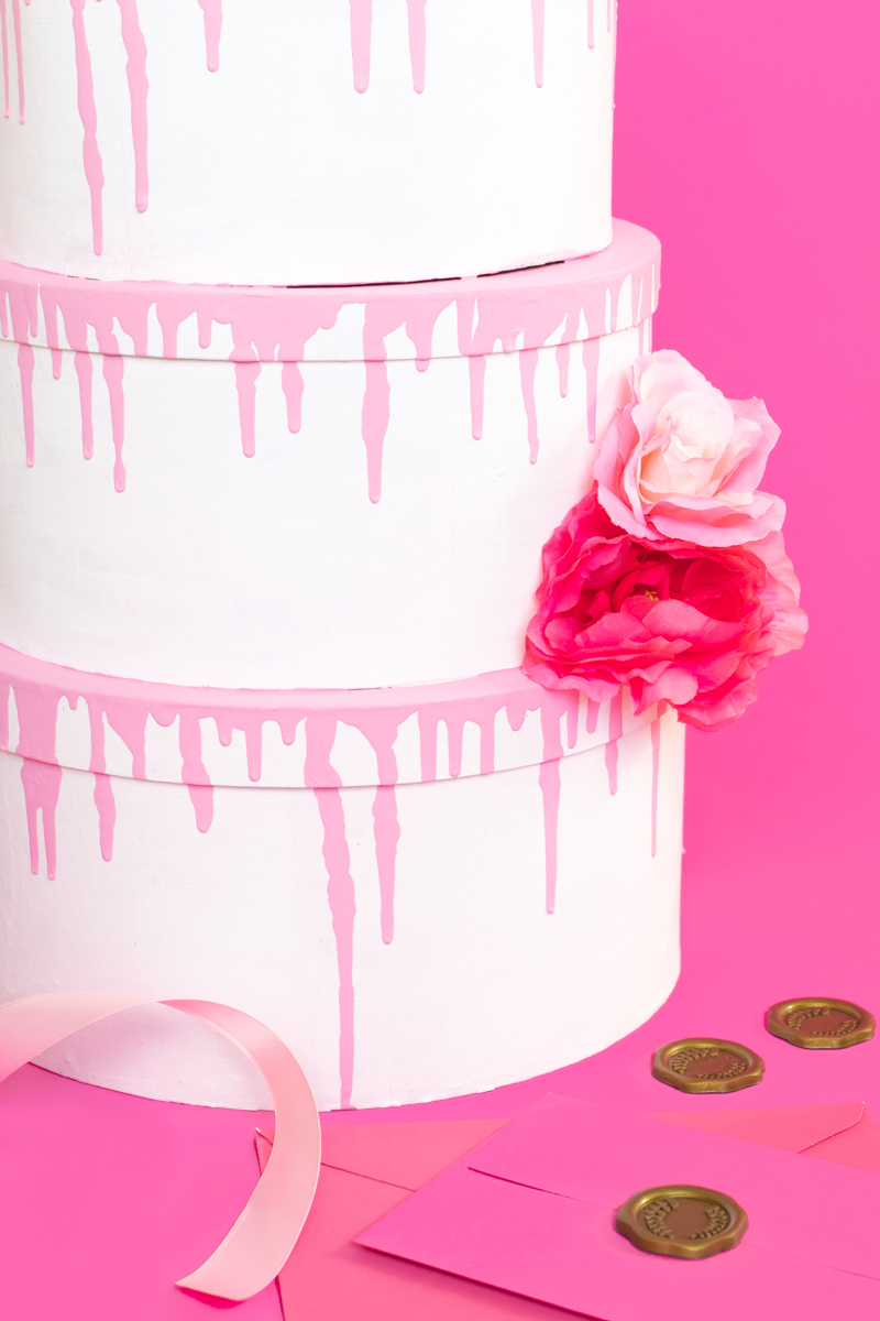 Tiered Cake Card Box DIY // DIY Wedding Card Box // Stack mache boxes into a tiered cake shape with the middles cut out to create a faux cake DIY card box that's perfect for weddings and events! This easy wedding DIY is the perfect way to customize your gift table #weddingdiy #papercrafts #mache #cakedecorating #diywedding #handmadewedding #cardbox