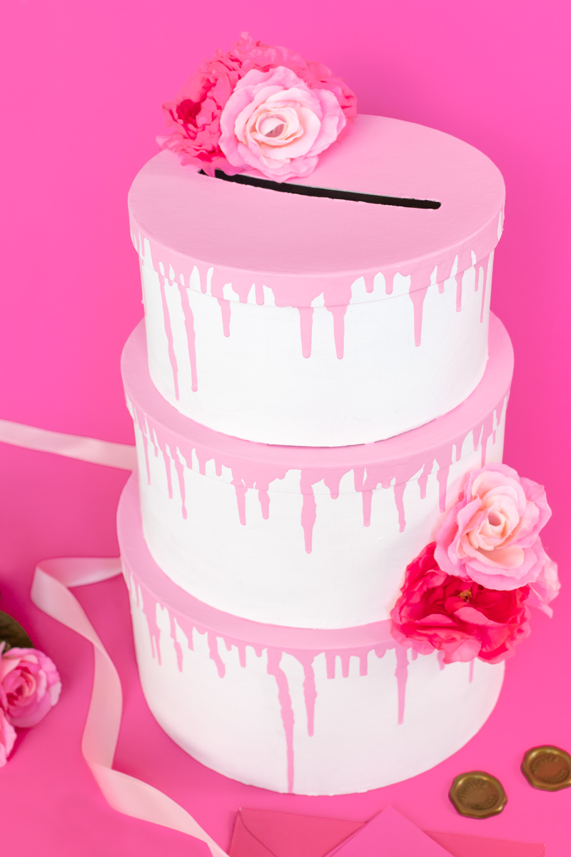 Tiered Cake Card Box DIY // DIY Wedding Card Box // Stack mache boxes into a tiered cake shape with the middles cut out to create a faux cake DIY card box that's perfect for weddings and events! This easy wedding DIY is the perfect way to customize your gift table #weddingdiy #papercrafts #mache #cakedecorating #diywedding #handmadewedding #cardbox