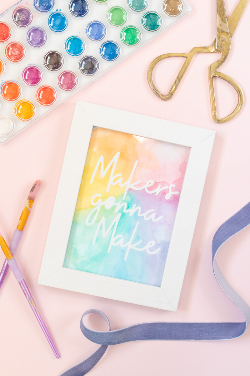 Easy Watercolor Artwork Hack // Follow this quick watercolor tutorial video to learn how to make graphic art that pops off the paper! Using vinyl as a stencil, create rainbow artwork in minutes with simple watercolors! #watercolor #artwork #painting #vinyl #cricutmade #handmadewithjoann #rainbow #wallart #diyideas #diyart