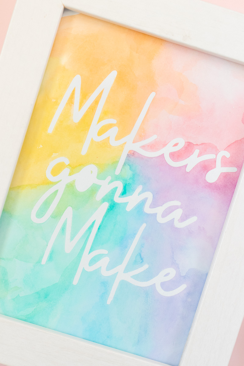 Easy Watercolor Artwork Hack // Follow this quick watercolor tutorial video to learn how to make graphic art that pops off the paper! Using vinyl as a stencil, create rainbow artwork in minutes with simple watercolors! #watercolor #artwork #painting #vinyl #cricutmade #handmadewithjoann #rainbow #wallart #diyideas #diyart