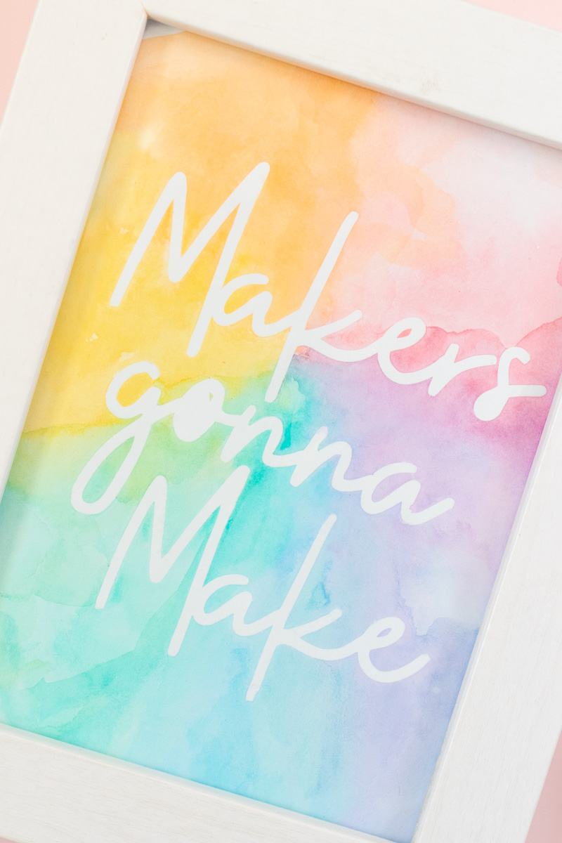 Easy Watercolor Artwork Hack // Follow this quick watercolor tutorial video to learn how to make graphic art that pops off the paper! Using vinyl as a stencil, create rainbow artwork in minutes with simple watercolors! #watercolor #artwork #painting #vinyl #cricutmade #handmadewithjoann #rainbow #wallart #diyideas #diyart