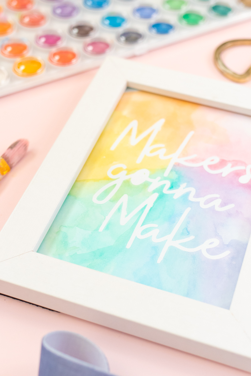Easy Watercolor Artwork Hack // Follow this quick watercolor tutorial video to learn how to make graphic art that pops off the paper! Using vinyl as a stencil, create rainbow artwork in minutes with simple watercolors! #watercolor #artwork #painting #vinyl #cricutmade #handmadewithjoann #rainbow #wallart #diyideas #diyart