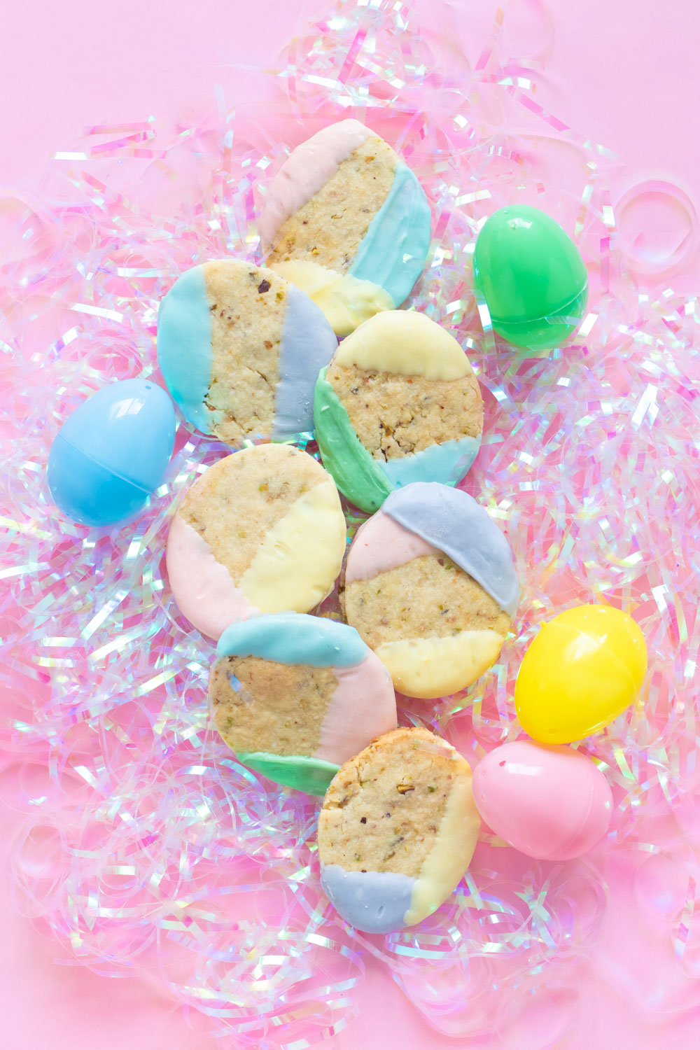 Layered Easter color blocked cookies on shredded plastic