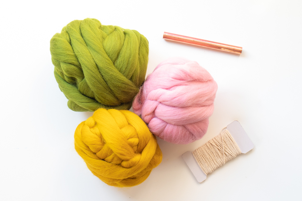 colorful roving, copper pipe and string for weaving project