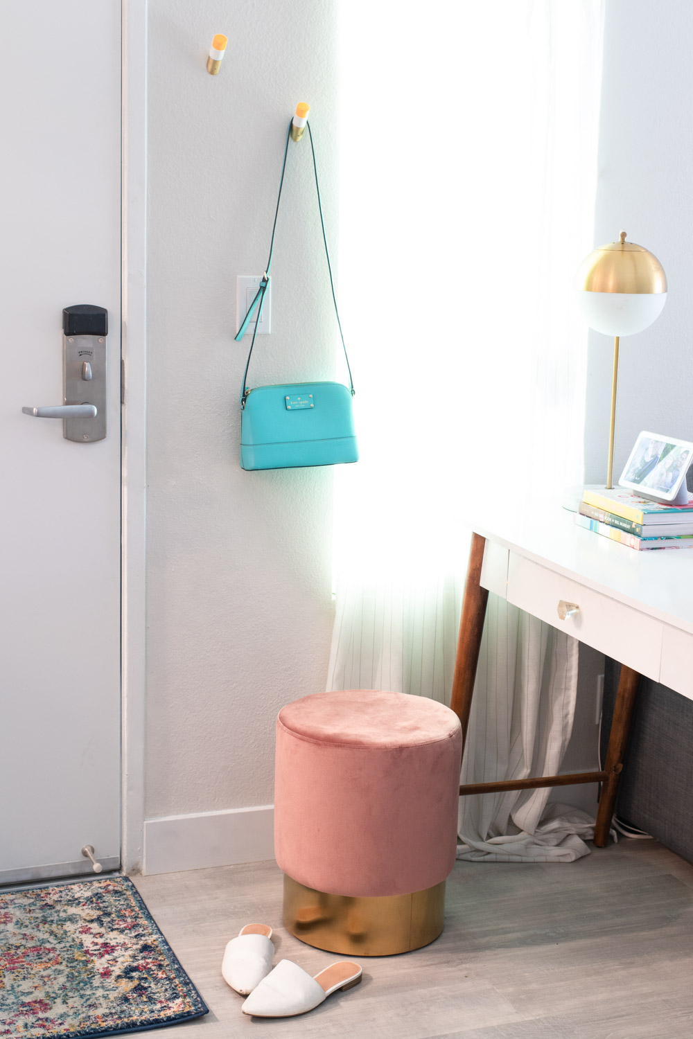 pink ottoman in small space entryway