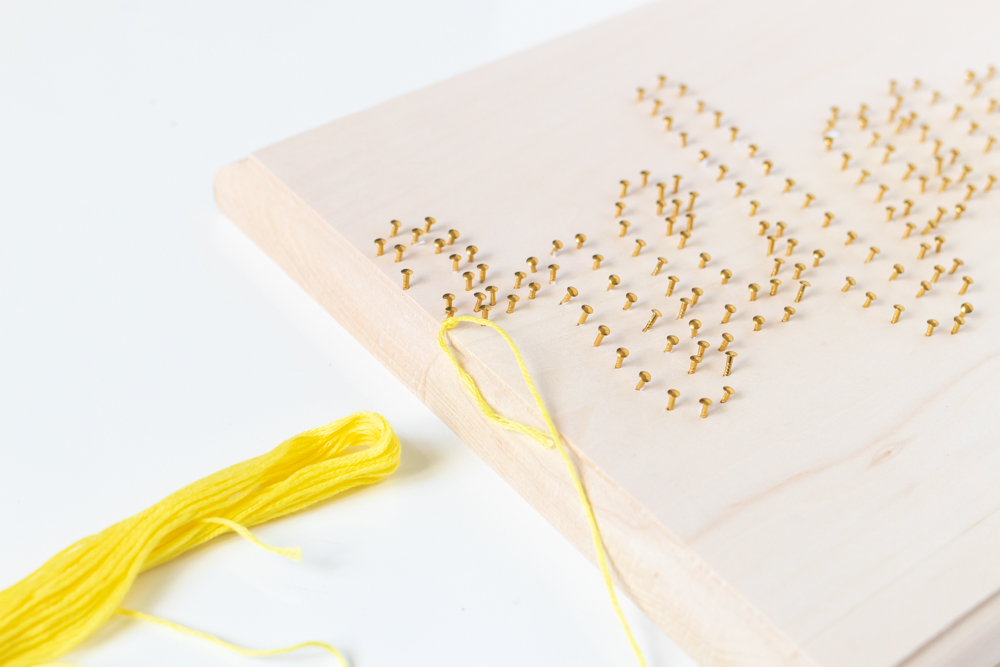 knot with embroidery thread around a nail