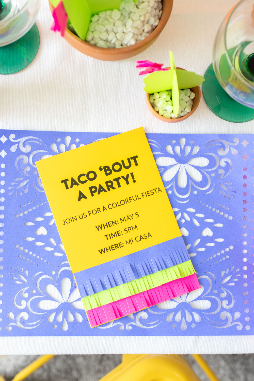fringe invitations for fiesta party on purple placemats