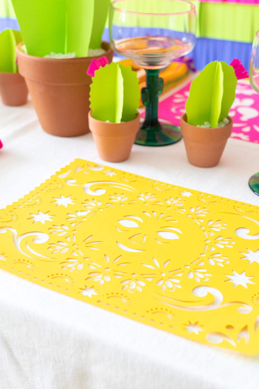 papel picado placemat design on white tablecloth with paper cacti