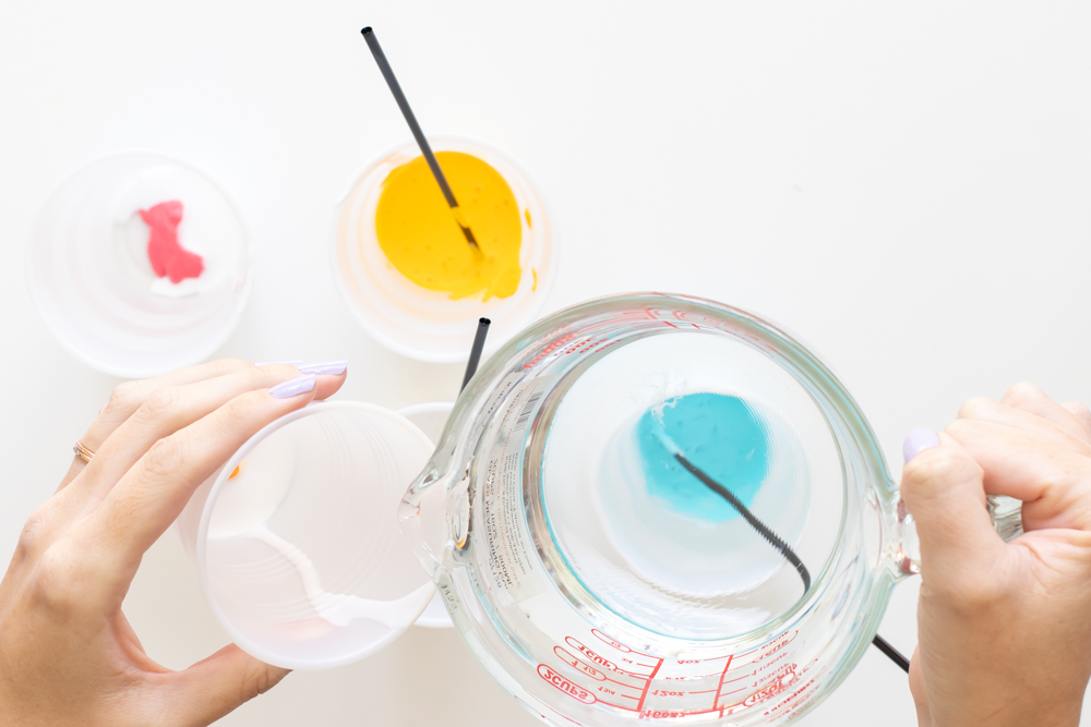 pouring water into fluid painting mixture