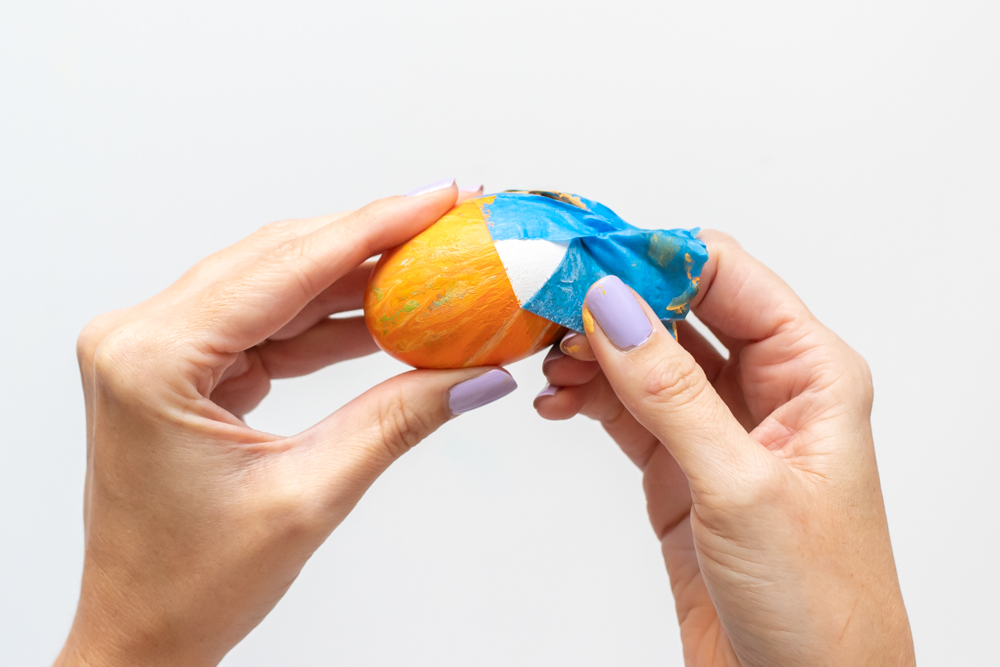 peeling tape off of fluid painted egg