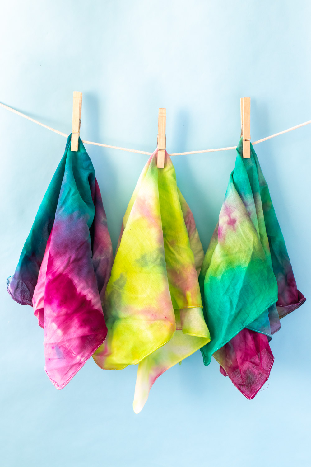 three tie dye handkerchiefs on clothesline