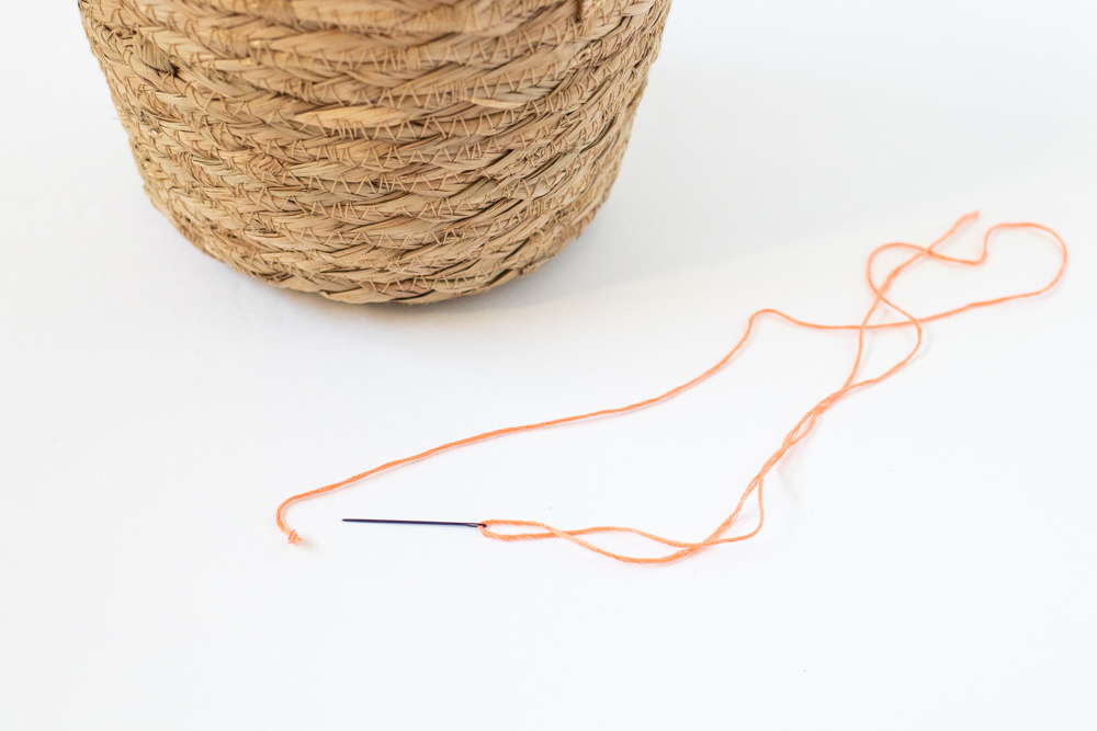 needle threaded with embroidery floss
