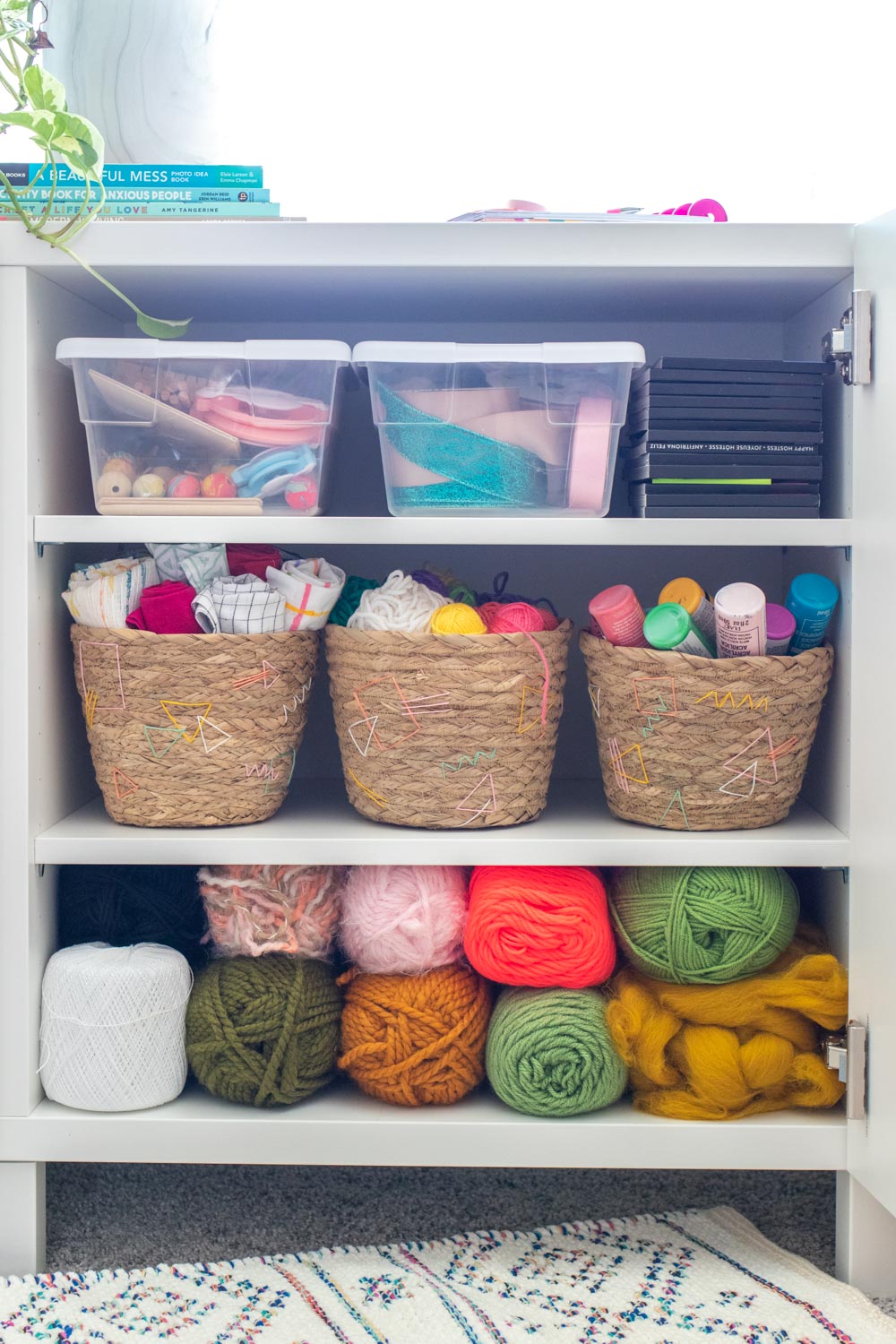 3 baskets with embroidery detail on craft shelf