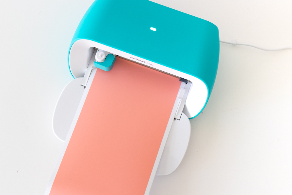 feeding coral vinyl into Cricut Joy machine