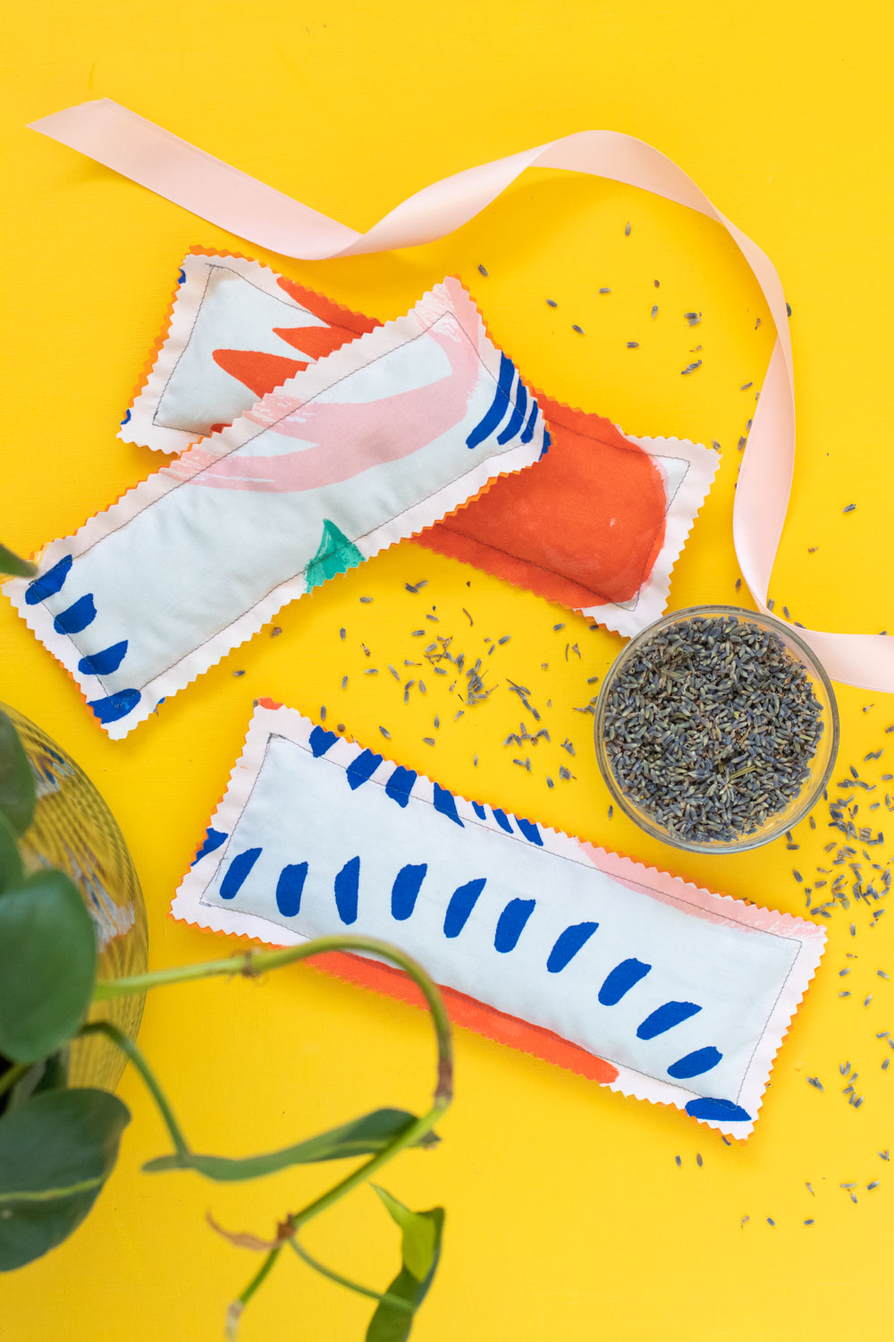 three lavender eye masks on yellow background