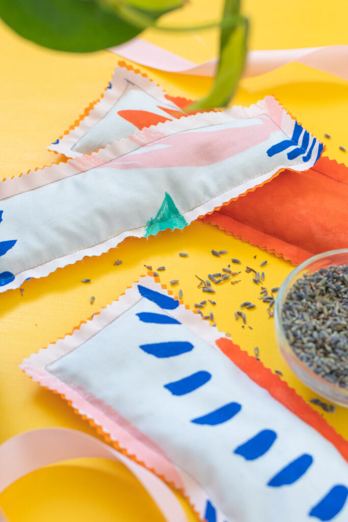sewn eye mask filled with rice and lavender on yellow background