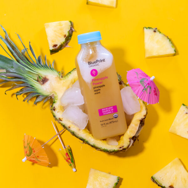 food photography of BluePrint juice with pineapple on yellow background