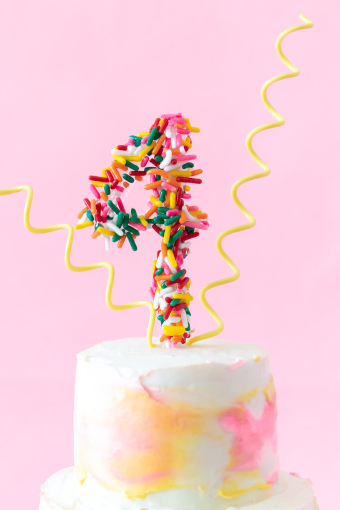 closeup of DIY sprinkle number cake topper