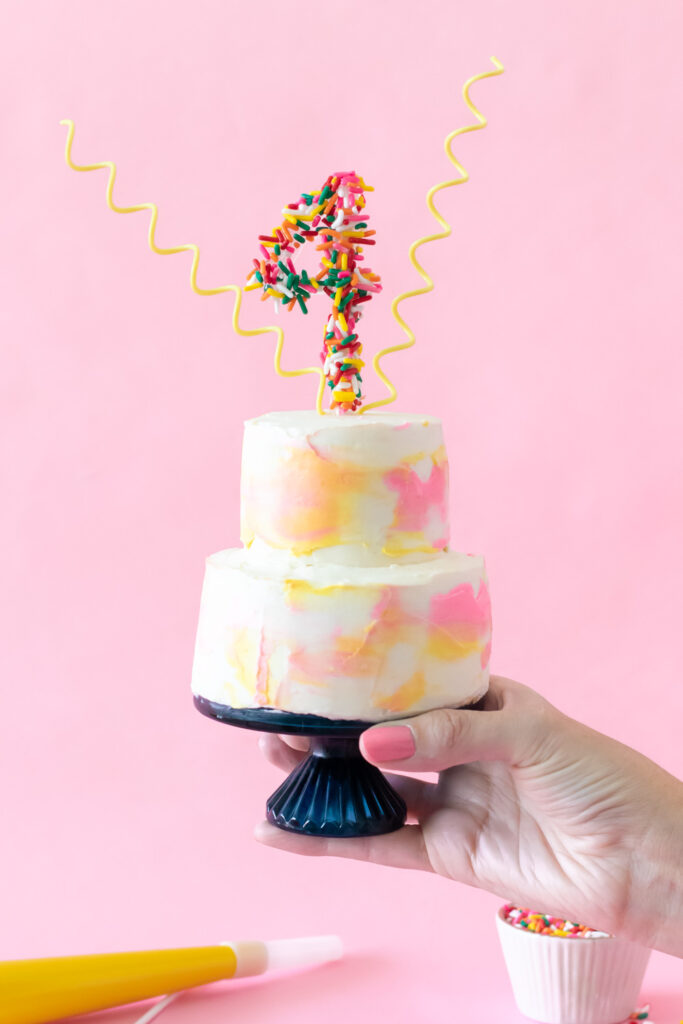 holding up miniature cake for scale