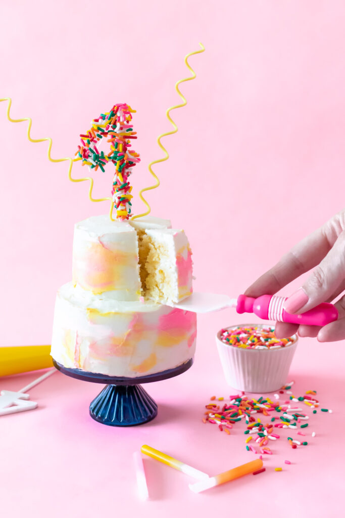 cutting small cake with toy serving utensil