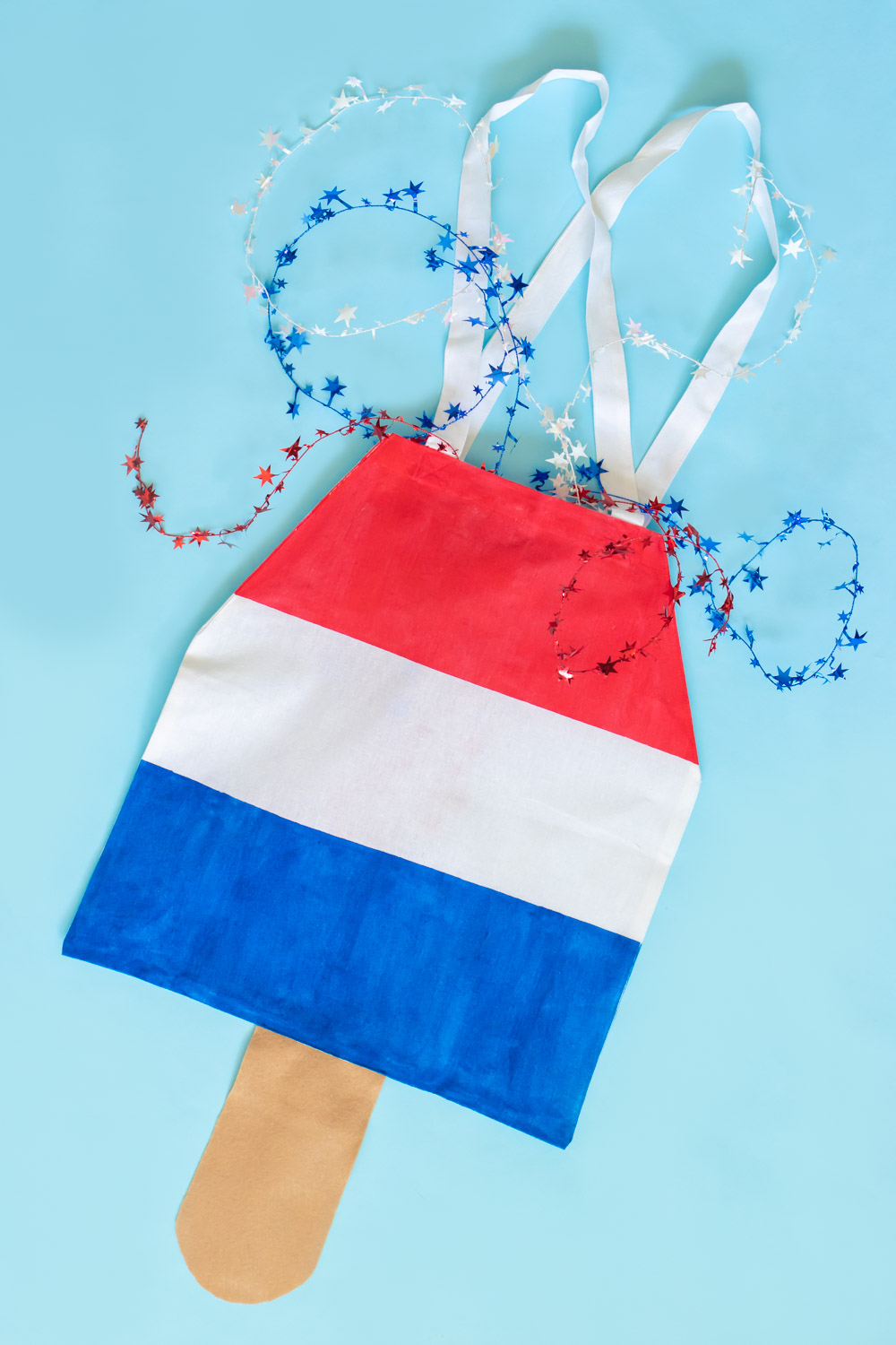 flatlay of rocket pop tote on blue with stars