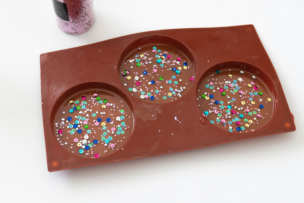 confetti sprinkled on resin coasters in mold