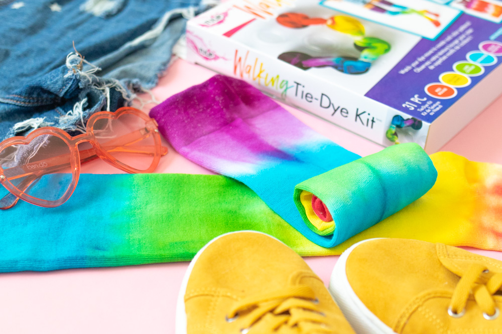 rolled up tie dye socks surrounded by accessories