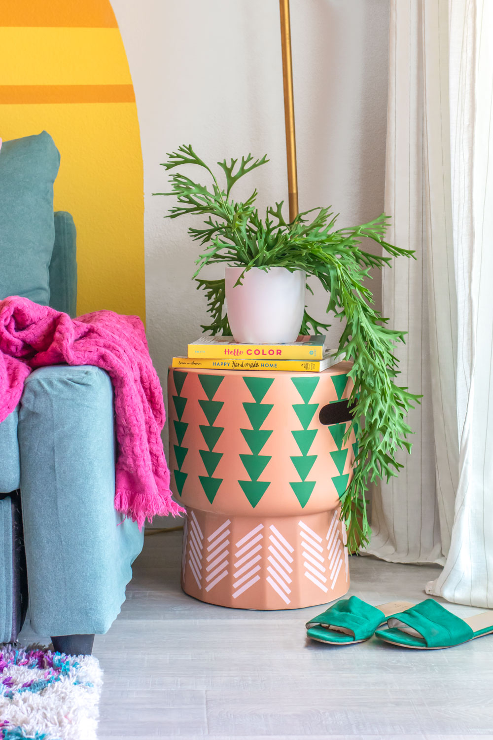 stenciled side table with books and plant in living room