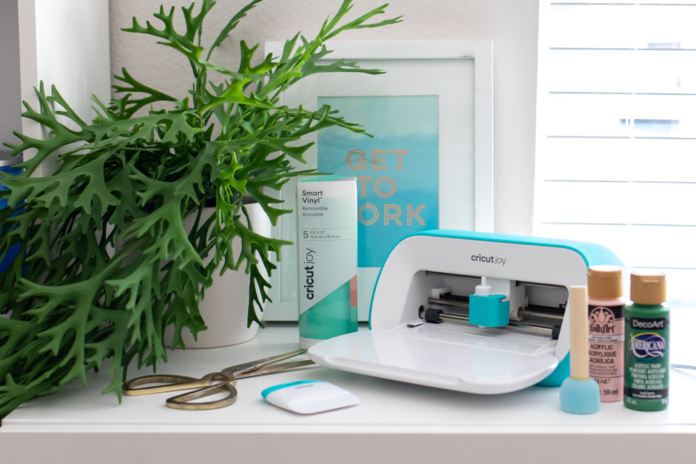 Cricut Joy with vinyl and craft supplies for making stenciled side table