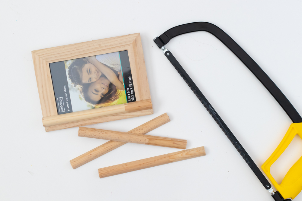 saw and pieces of trim for decorating picture frame