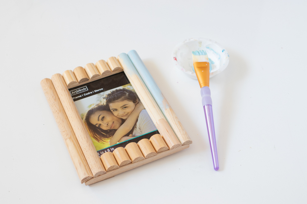 process of painting a photo frame decorated with trim