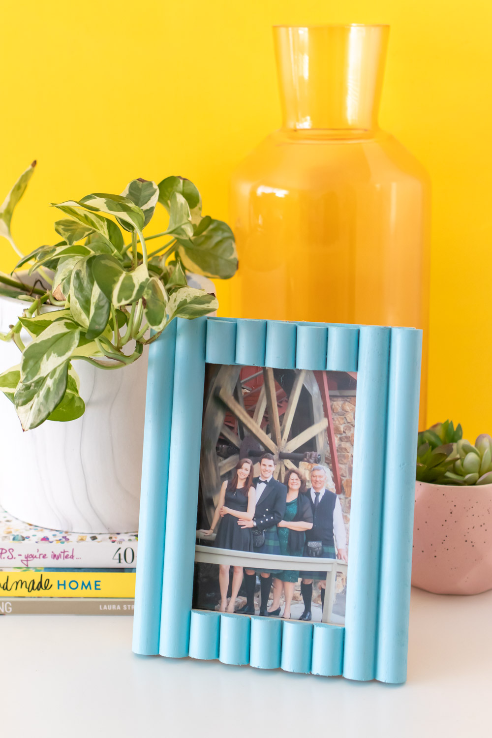 easy photo frame update with trim on table with plant