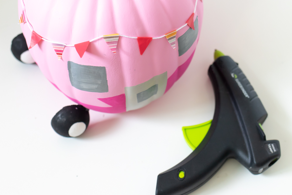 gluing washi tape bunting to pumpkin
