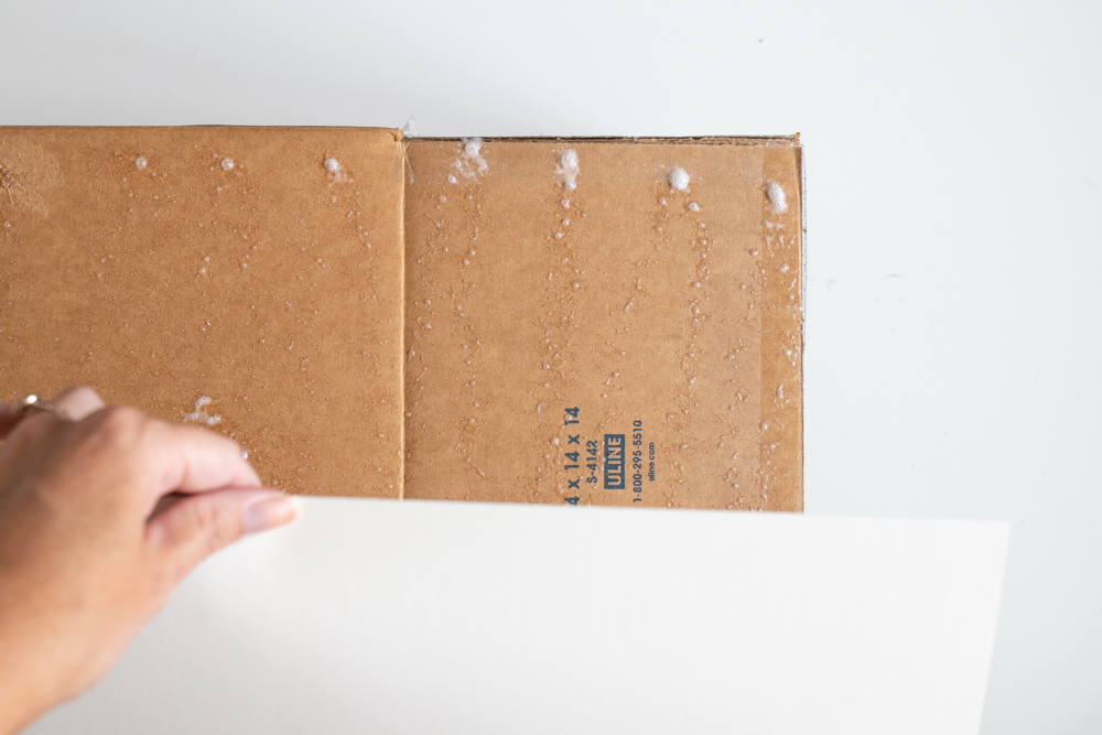 sticking poster board to cardboard box