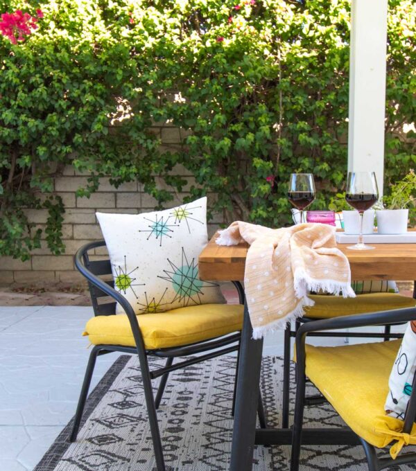 fall outdoor dining space with mid-century patterned pillows