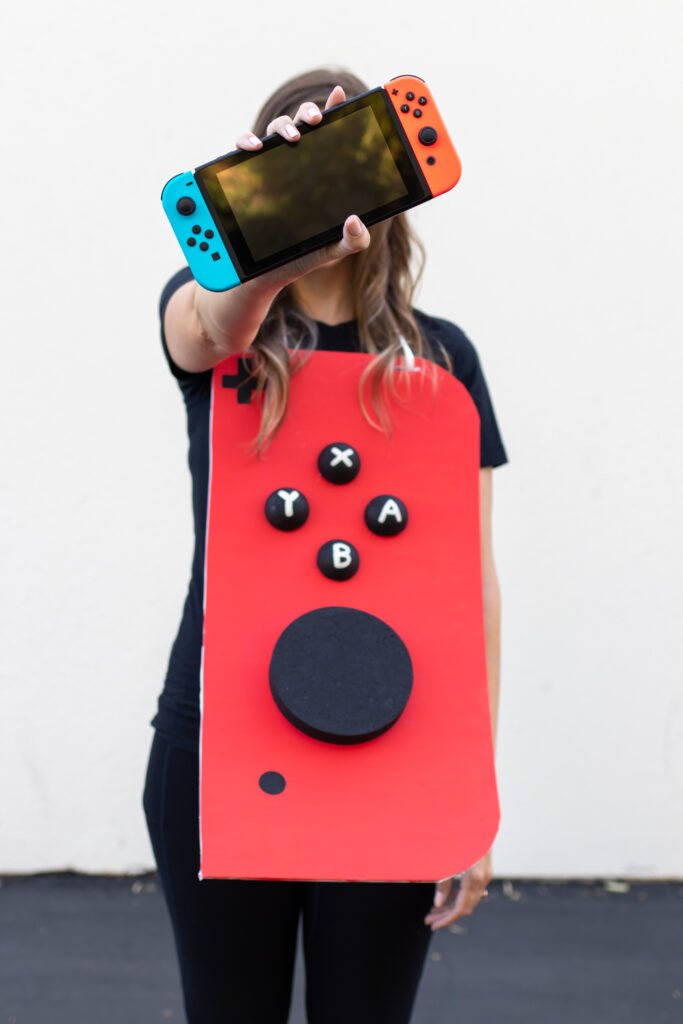 woman in video game couples costume holding Nintendo Switch