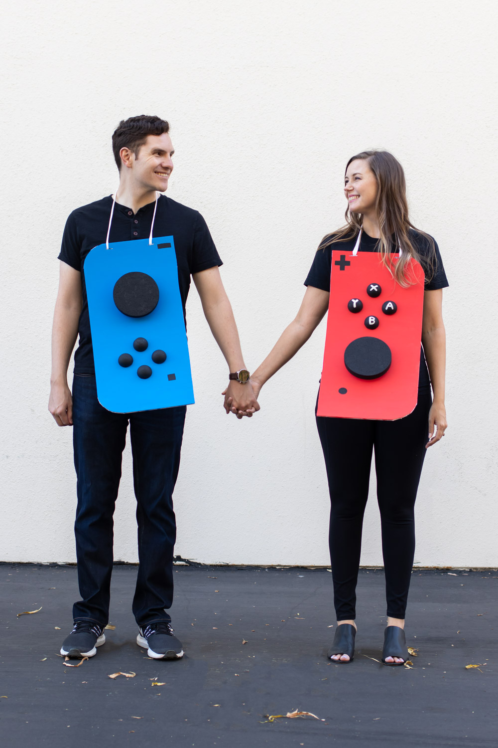 couple wearing Nintendo Switch costume against white background