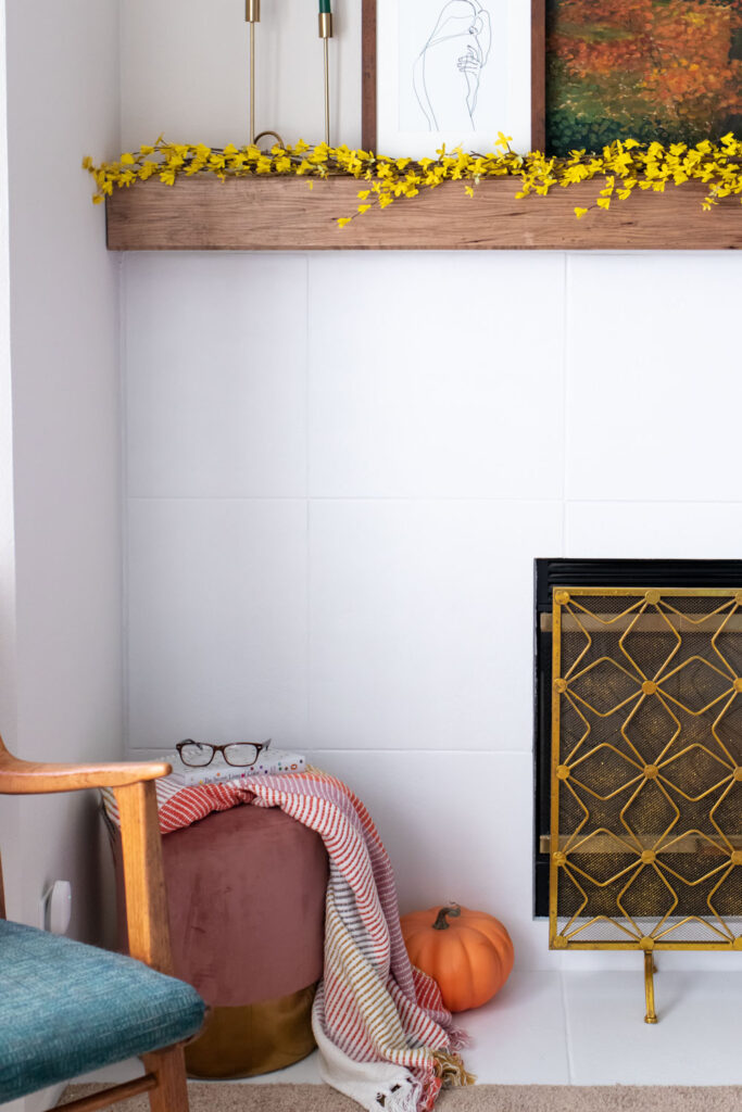 view of white painted tile fireplace with modern decor