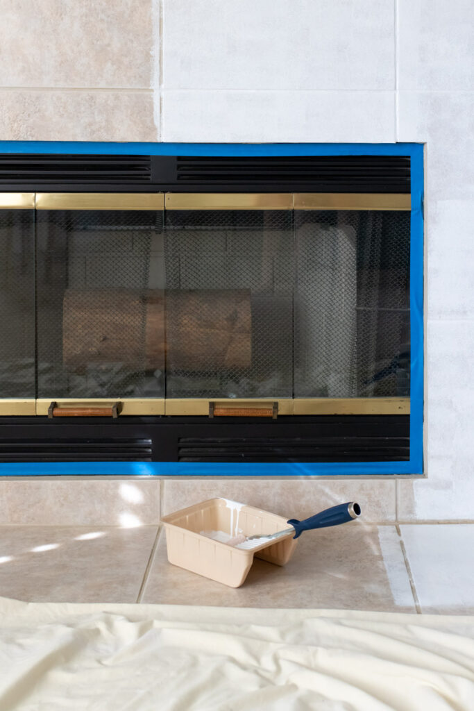 halfway through painting a tile fireplace