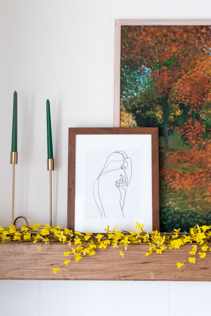 photos on a DIY mantel and painted tile fireplace